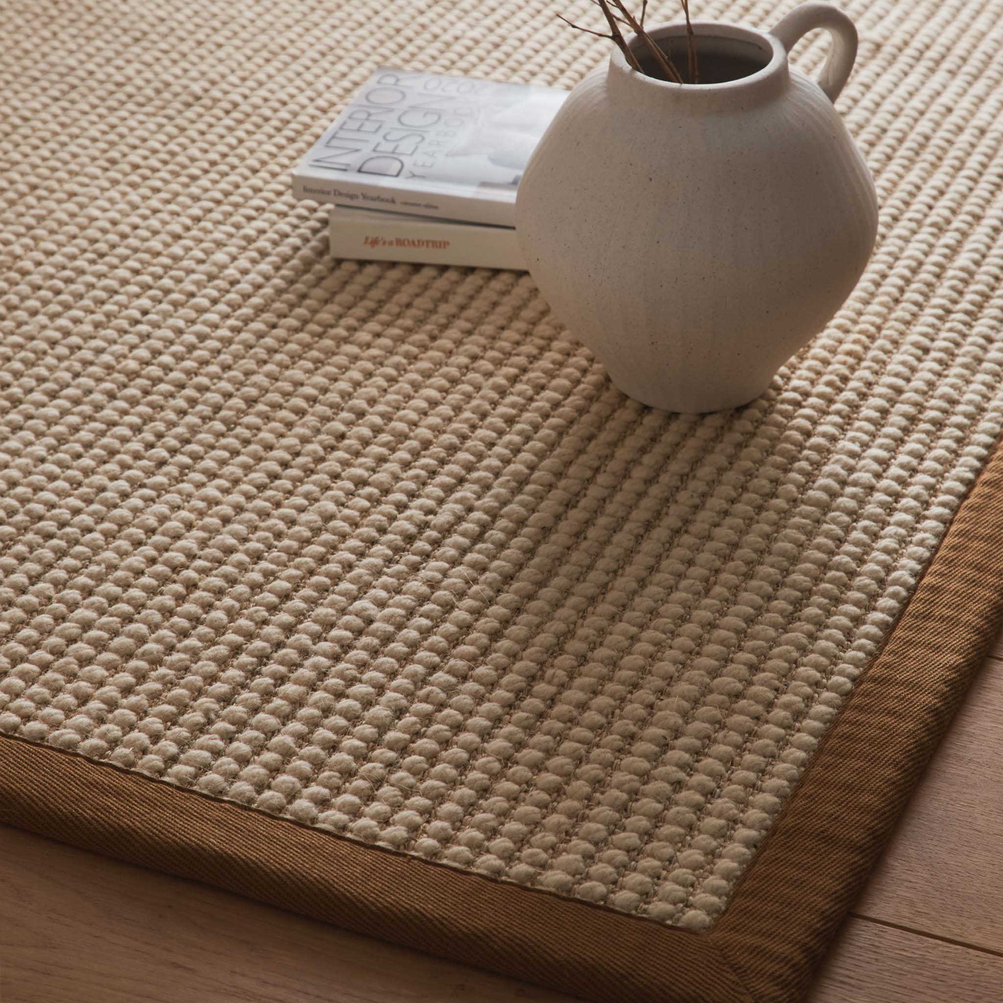 Origins Sisal Boucle with Mocha Border- made from sisal wool blend featuring a brown border.