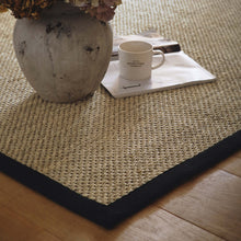 Load image into Gallery viewer, Origins Sisal Light Beige with Black Border- made from 100% sisal featuring a black border.
