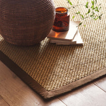 Load image into Gallery viewer, Origins Sisal Warm Natural with Dark Brown Border- a natural rug made from 100% sisal featuring a brown border.
