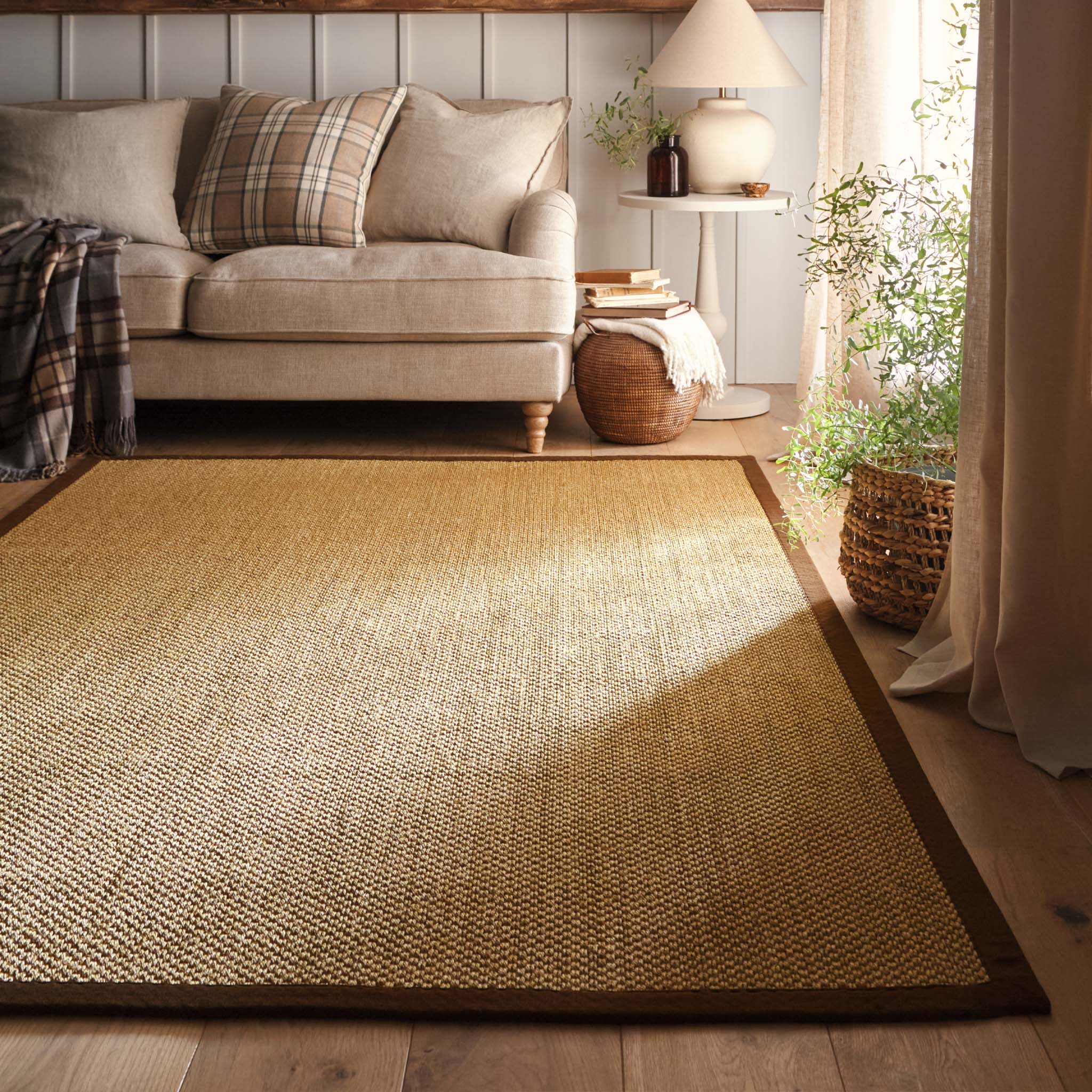 Origins Sisal Warm Natural with Dark Brown Border- a natural rug made from 100% sisal featuring a brown border.